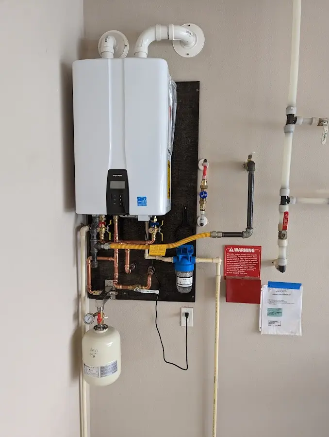 Professional plumber installing copper piping in a Ridgefield home